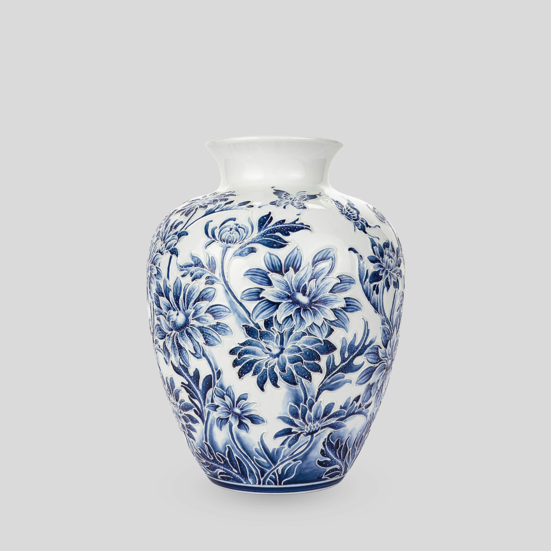 A blue and white vase sitting on top of a table